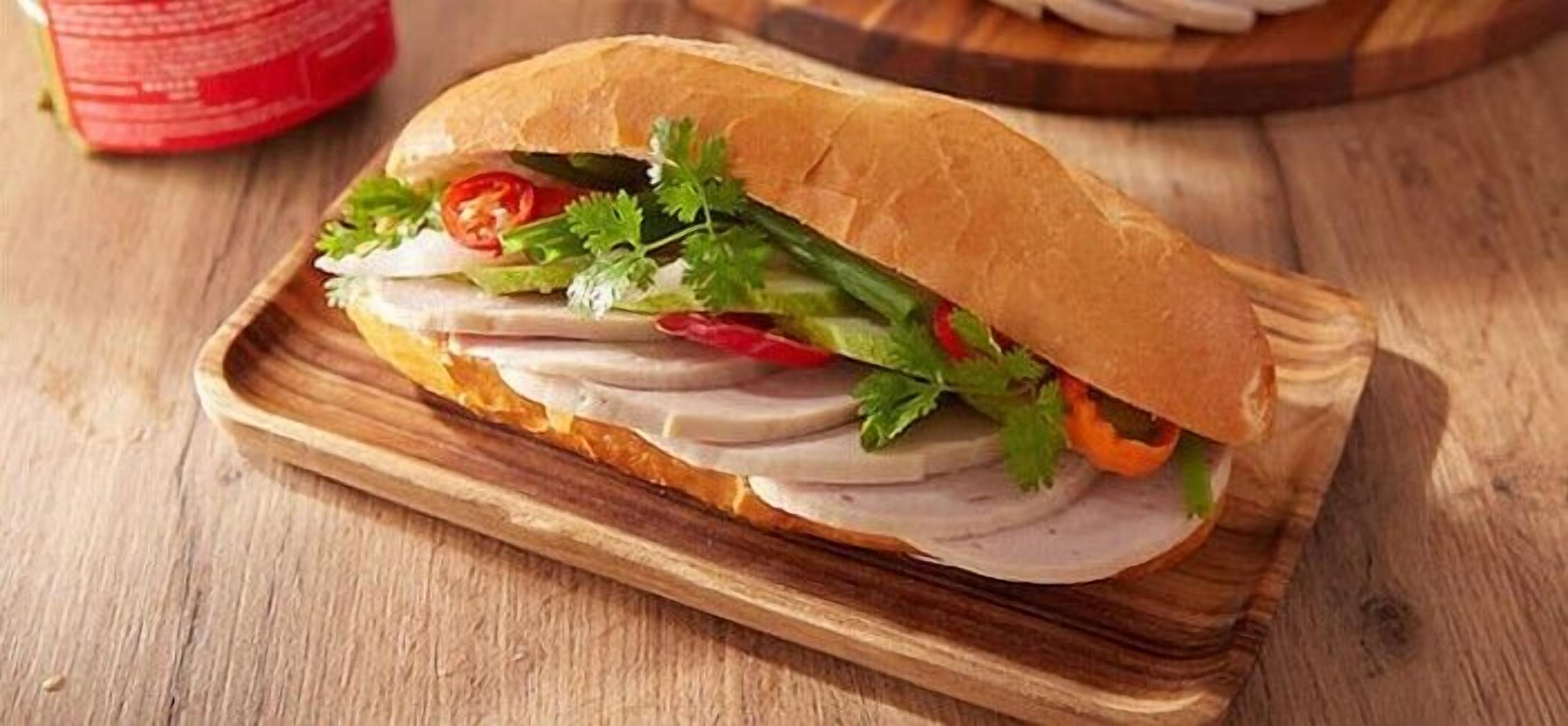 A sandwich on a wooden board.