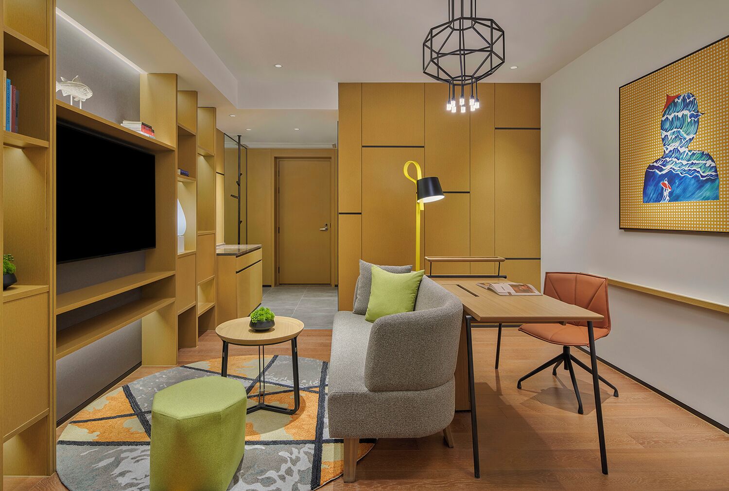 A modern living room with a sofa, a dining table, a TV, and a bookshelf.