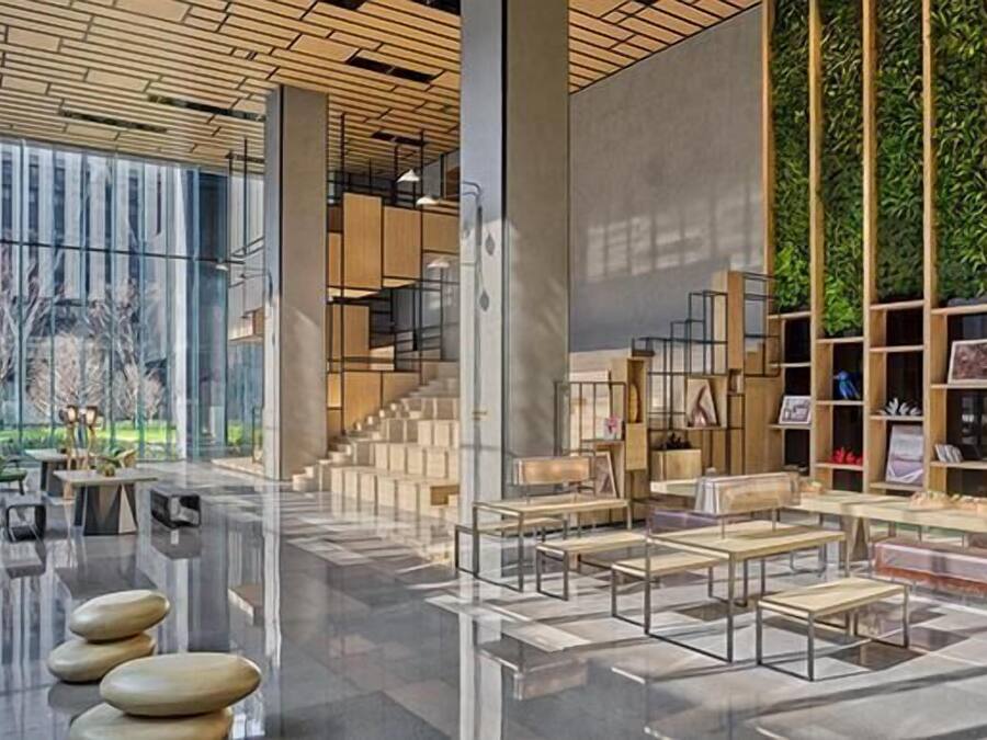 A modern interior with a glass facade, wooden flooring, and a central staircase.