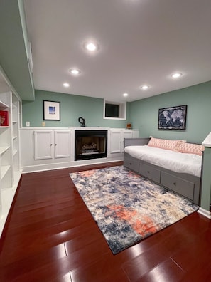 A bedroom with a bed, a fireplace, a rug, and a world map on the wall. - Society Hill, Historical Home, 3BD/2.5BA (Philadelphia)