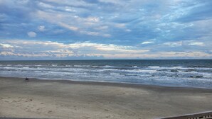 A beach with a wide sandy shore and the ocean. - Ocean View Retreat! Pets, Fenced, Community Pool (Galveston)