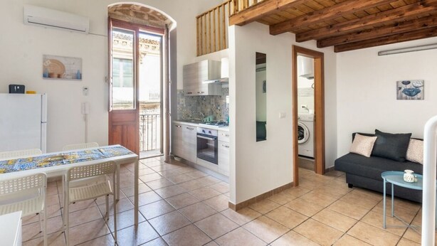 A compact living space with a kitchen, dining area, and seating area. - Iblea House - One Bedroom Apartment, Sleeps 4 (Avola)