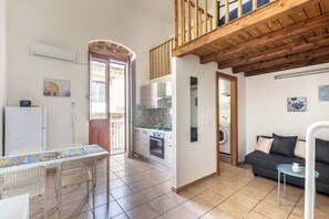 Ein kompakter Wohnbereich mit Küche, Essbereich und einem Balkon.