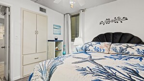 A bedroom with a bed, a wardrobe, a window with blinds, and a ceiling fan. - Seaside Serenity Sunbird 503W-Gorgeous Beach Views! Comp Beach Service! (Panama City Beach)