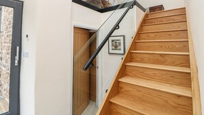 A staircase with wooden steps and a glass railing.
