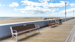 A wooden boardwalk with benches overlooking a beach. - 3 br / 2 bath for 10, direct beach/ocean and boardwalk views~ (Ocean City)