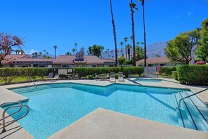 A swimming pool with lounge chairs and palm trees. - Fab 2br/2ba Condo, Superior Views at Mesquite Country Club (Palm Springs)
