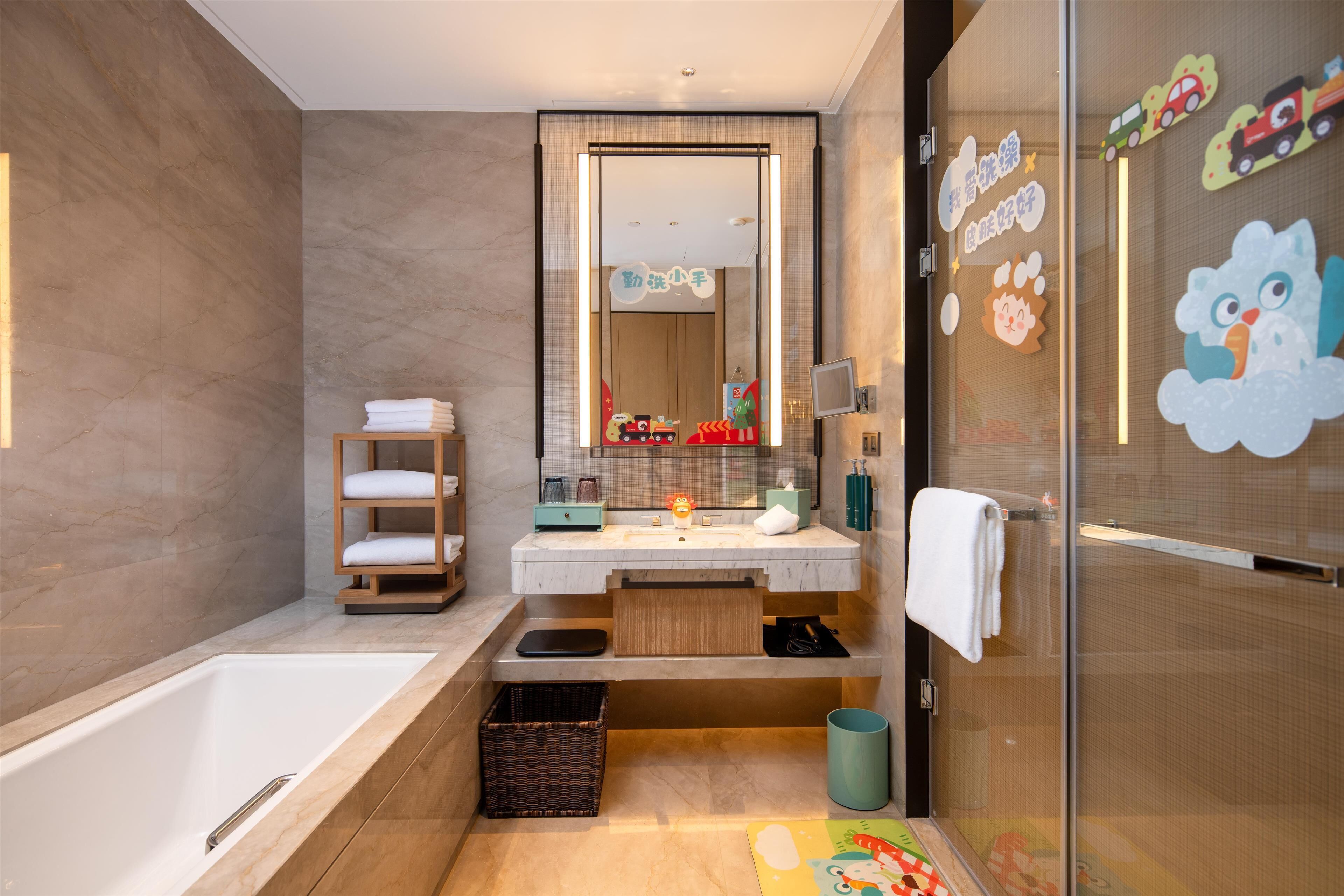 Une salle de bain moderne avec une baignoire, un meuble-lavabo et une cabine de douche en verre.