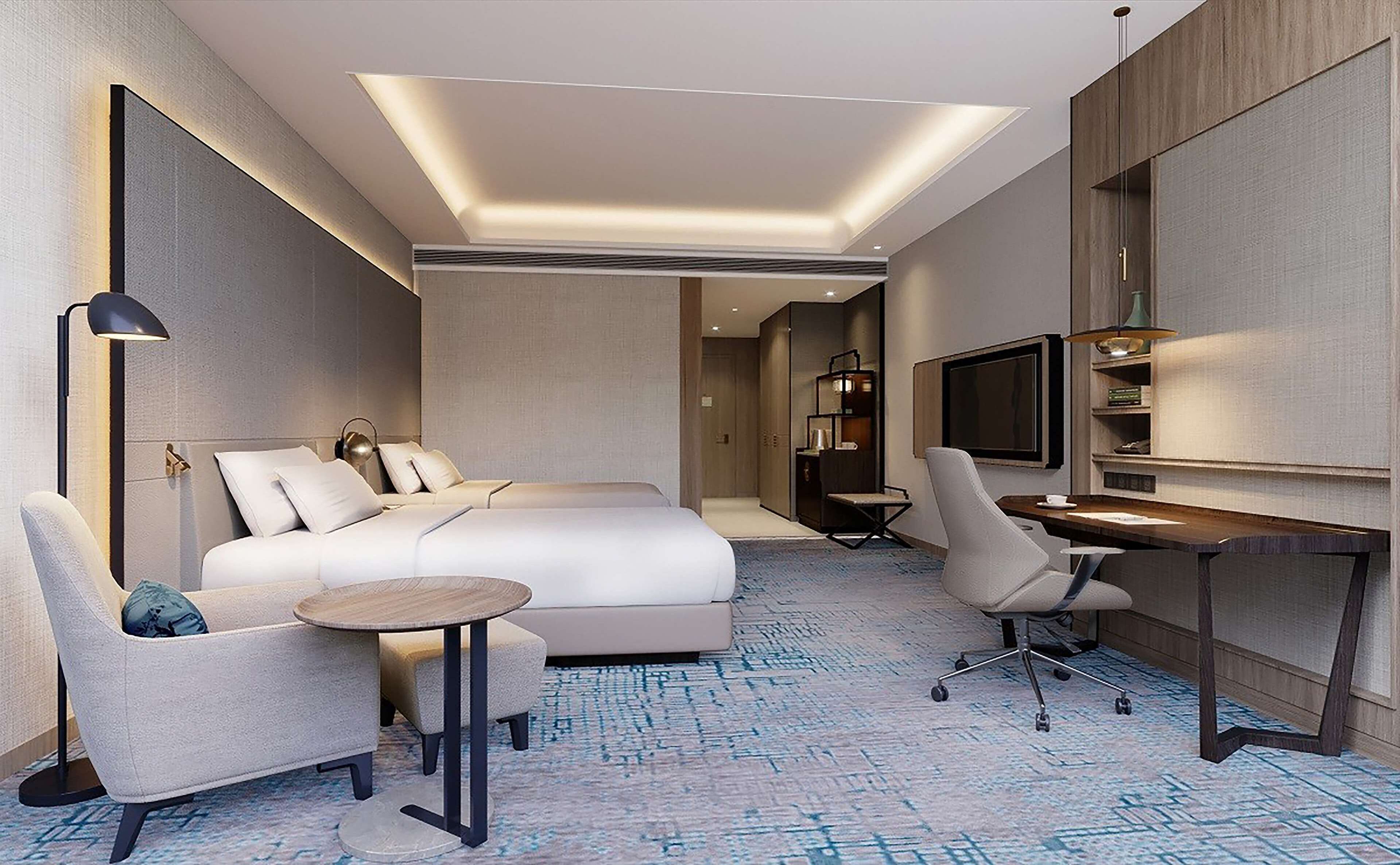 Une chambre d’hôtel moderne équipée d’un lit, d’un bureau, d’une chaise, d’une télévision et d’une lampe.