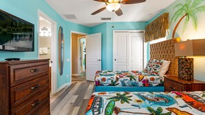 A bedroom with a bed, dresser, ceiling fan, and a TV on the wall. - 😎RELAX at Windsor Hills🌴, minutes to Disney - 5 bed / 5 bath, Private Pool🌞 (Kissimmee)