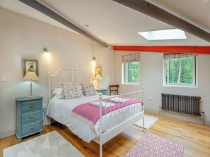 A bedroom with a bed, bedside tables, a nightstand, a window, and a radiator. - Ground Floor: 
Open plan living space. (Midgham)