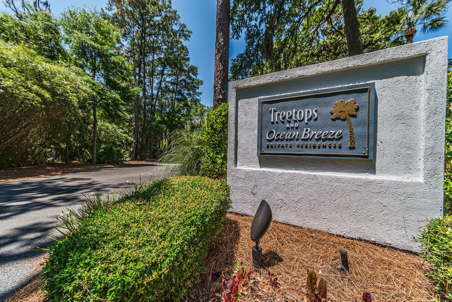 A sign for 'Treetops and Ocean Breeze' private residence.