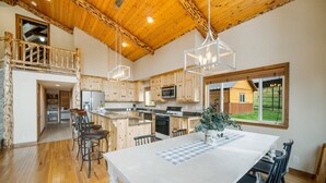 A spacious kitchen with wooden cabinets, a large island, and modern appliances. - Welcome to Lemon Lodge! Relax and unwind in this private and secluded cabin.  (Durango)