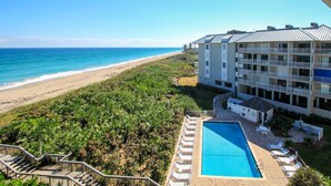 A hotel with a pool, beach view, and multiple balconies. - Beautiful bright, updated 2 bedroom, 2 bath oceanfront condo spectacular views! (Stuart)