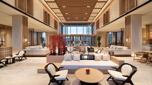 A spacious lobby with a central seating area, large windows, and a modern ceiling design. - Crowne Plaza Zunhua Hot Spring Town by IHG (Tangshan)
