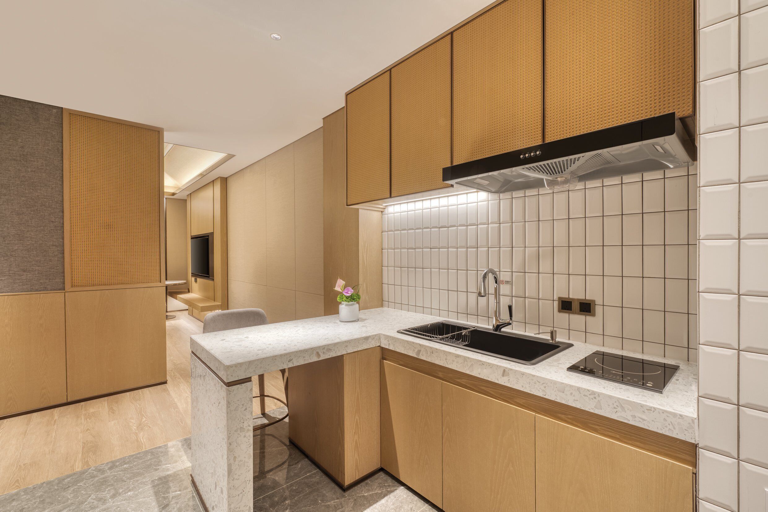A modern kitchen with a built-in stove, sink, and wooden cabinets.