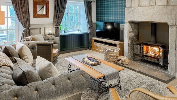 A cozy living room with a sofa, a coffee table, a fireplace, and a television. - 3 bedroom accommodation in Midgehole, Hebden Bridge (Midgehole, Hebden Bridge)
