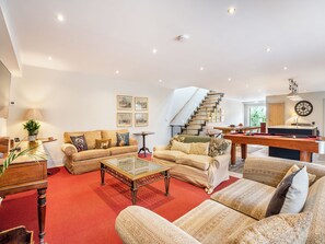 A spacious living room with a sofa set, a coffee table, and a pool table. - Ground Floor: 
Open plan living space. (Midgham)