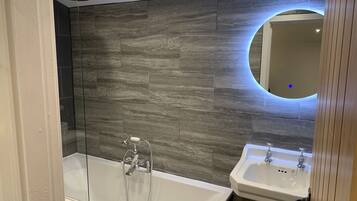 Combined shower/bathtub, hair dryer, towels, toilet paper