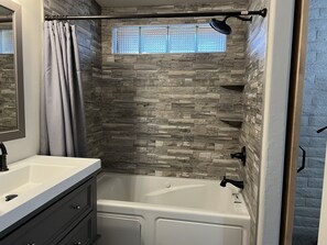 Bathtub, jetted tub, hair dryer, towels