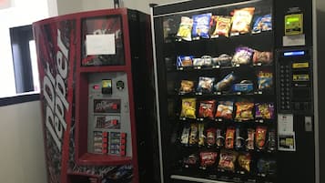 A vending machine with a variety of snacks and a separate section for Dr Pepper.