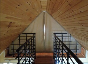 Attic space with wooden planks and metal railings.