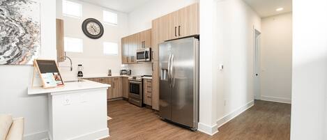 Microwave, dishwasher, coffee/tea maker, cookware/dishes/utensils