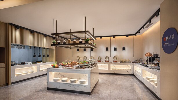 A modern breakfast buffet with marble countertops, a variety of food options, and a clean, minimalist design. - Holiday Inn Express Beijing Yizhuang Center by IHG (Beijing)
