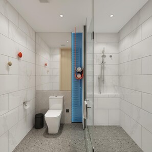 A modern bathroom with a glass shower enclosure, a toilet, and a sink.