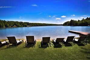 A lakeside view with a dock and lounge chairs facing the water. - The Grandview- Family and Pet Friendly  (Fort Ann)