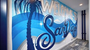 A mural with the text "WELCOME TO San Diego" and a palm tree silhouette.