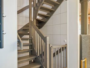 A spiral staircase with wooden steps and metal railings. - Pulkka 1 by Interhome (Salla)
