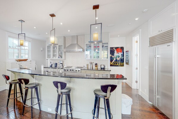 Enjoy cooking in this well-equipped kitchen with a central island, gas stove, and ample storage.
