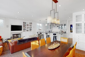 Relax in a spacious living area with a comfortable sofa, dining table, and flat-screen TV.