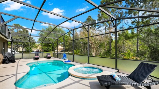 An outdoor swimming pool with a hot tub, surrounded by a covered patio with lounge chairs and a grill. - 

PerfectVacationHome5/4 Sleep12close to DisneyWorld, great forfamily gathering  (Kissimmee)
