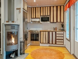 Een koelkast, een magnetron, een vaatwasser, kookgerei, borden en bestek