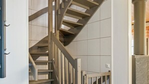 A spiral staircase with wooden steps and metal railings, leading to an upper floor. - Pulkka 2 by Interhome (Salla)