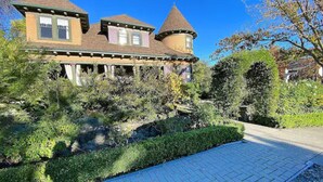 A large, two-story house with a turret and a wrap-around porch. - Pinschower Inn (Cloverdale)