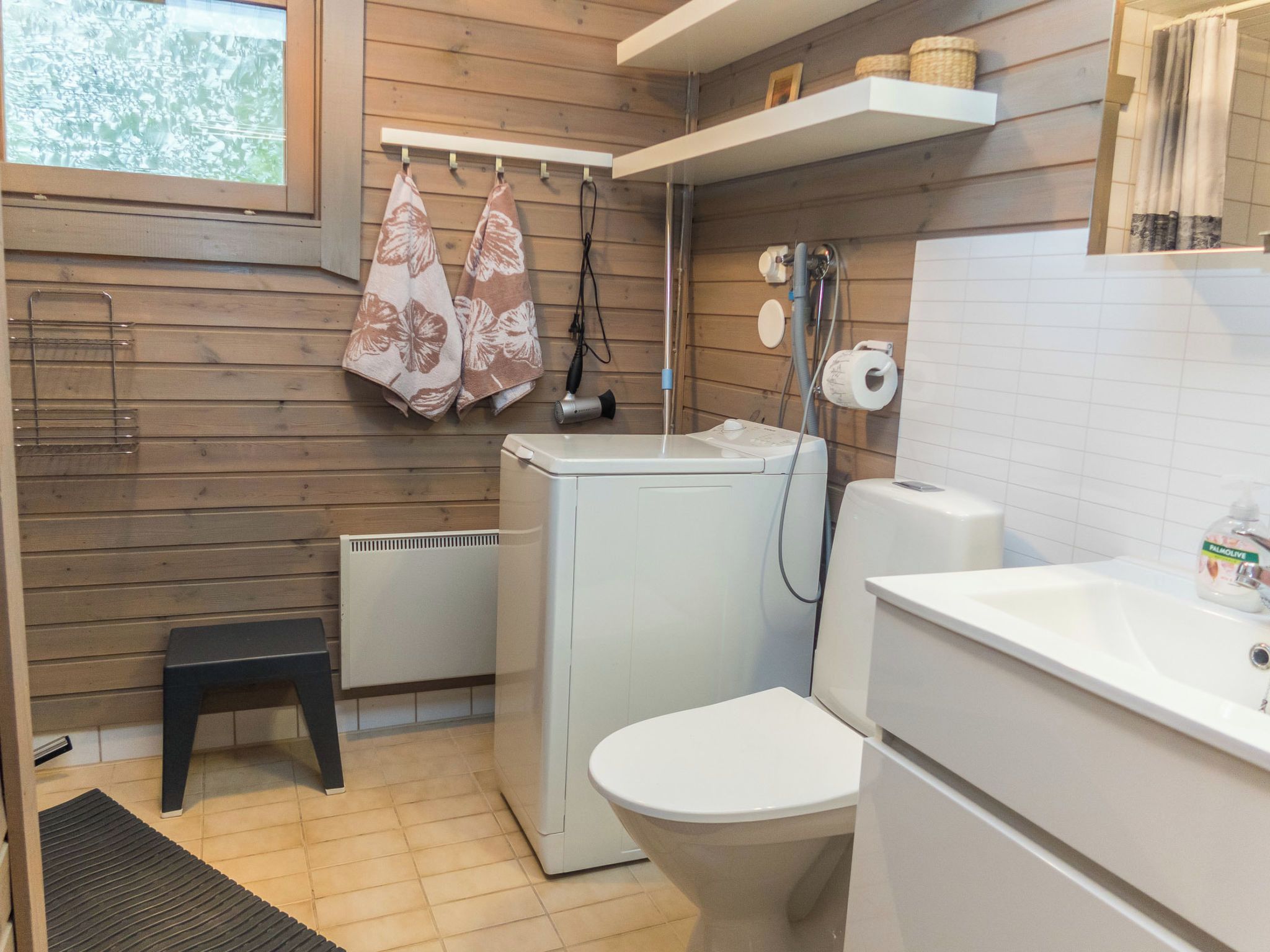 Un baño pequeño con ducha, inodoro y radiador.