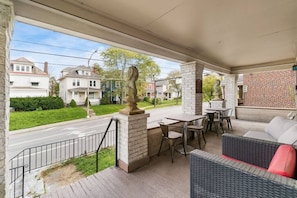 Your front porch includes outdoor seating, dining tables, couches and guard lions.