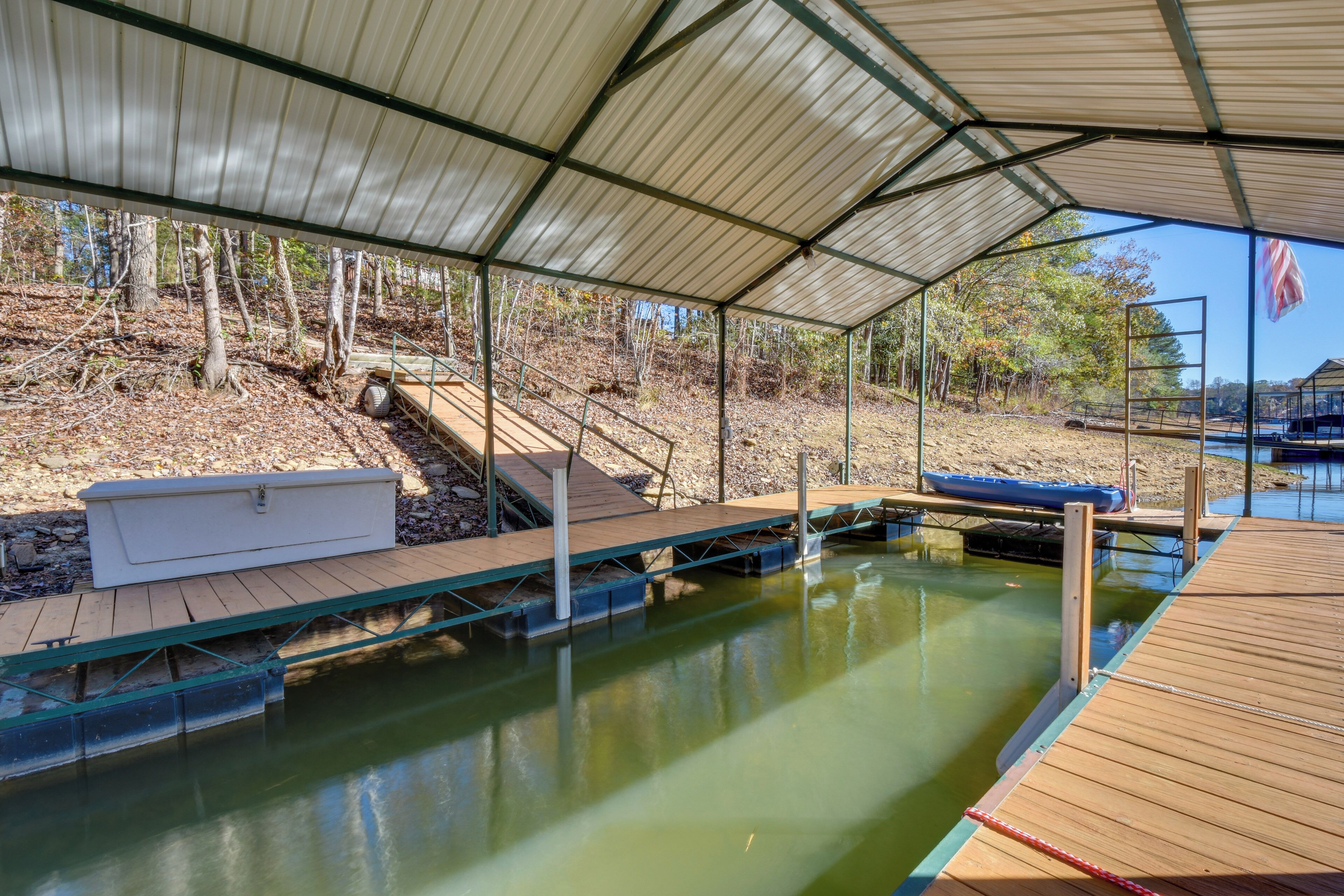 A covered swimming pool with a wooden deck, a white storage box, and a ladder. - Waterfront Lake Hartwell Home w/ Dock & Fire Pit (Hartwell)