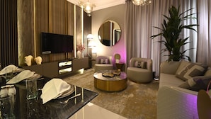 A modern living room with a flat-screen TV, round coffee table, and two sofas. - SLV Smart Living Villa (دبيdubai)