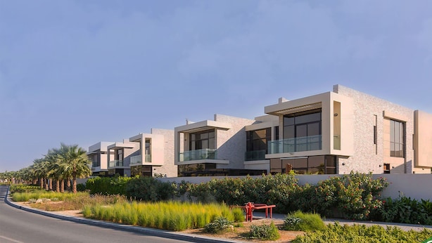 A modern building with multiple units, featuring large windows and a flat roof. - SLV Smart Living Villa (دبيdubai)