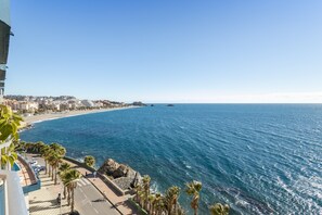 A coastal cityscape with a clear view of the sea, a paved promenade, and buildings along the shore. - Apartment with Sea View, Balcony, and Air Conditioning (Almunecar)