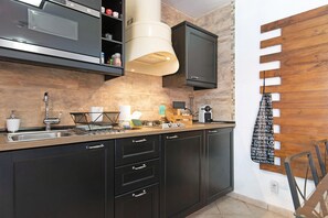 A modern kitchen with dark cabinetry, a stainless steel sink, and a built-in oven. - Holiday Villa 'La Quinta De Vals' with Mountain Views, Wi-Fi and Air Conditioning (Valsequillo)
