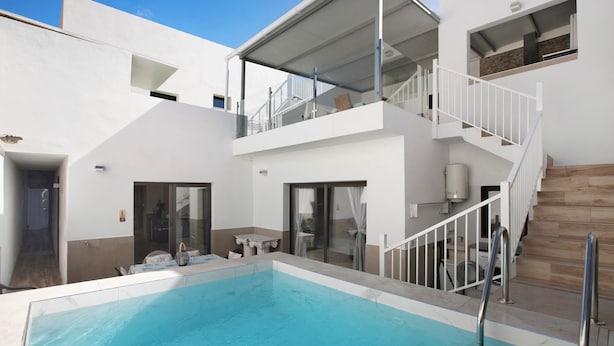 A modern building with a swimming pool, a staircase, and a balcony. - Villa Dolce Vita Tenerife Sur with Sea Views, Private Pool, Terraces, and Wi-Fi (Adeje)
