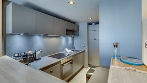 A modern kitchen with built-in appliances, a sink, and a countertop.