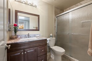 A bathroom with a marble sink, a toilet, and a glass shower enclosure. - **NEW** Beautiful Racquet Club Condo (Scottsdale)
