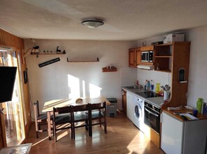 Enjoy cooking and cleaning in this compact kitchen with a washing machine and compact refrigerator.