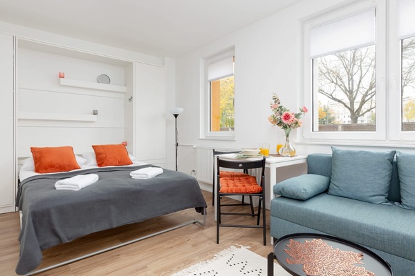 Studio with a double sofa bed, double bed and dining area.